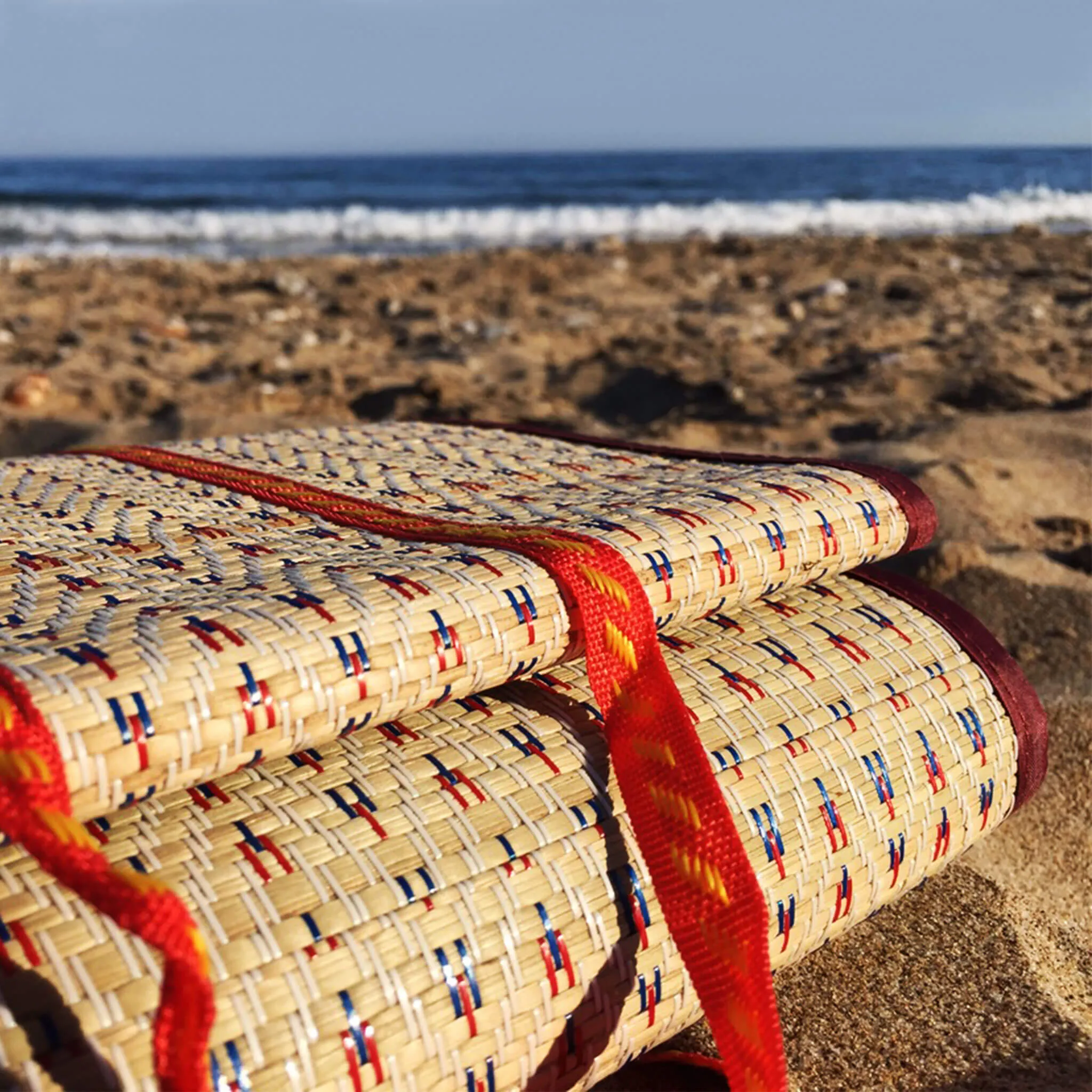 Handwoven Natural Reed Fold up Mat with Dark Red Trim